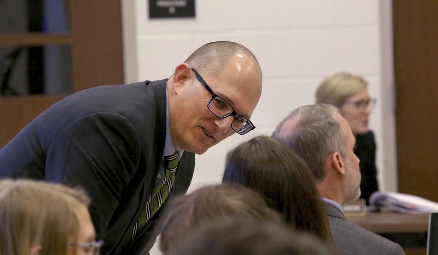 In this Thursday Dec. 6, 2018 photo, high school teacher Peter Vlaming chats at a West Point School Board hearing in West Point, Va. The board voted unanimously to dismiss Vlaming, a high school teacher who refused to use a transgender student&#x27;s new pronouns. (Shelby Lum/Richmond Times-Dispatch via AP)