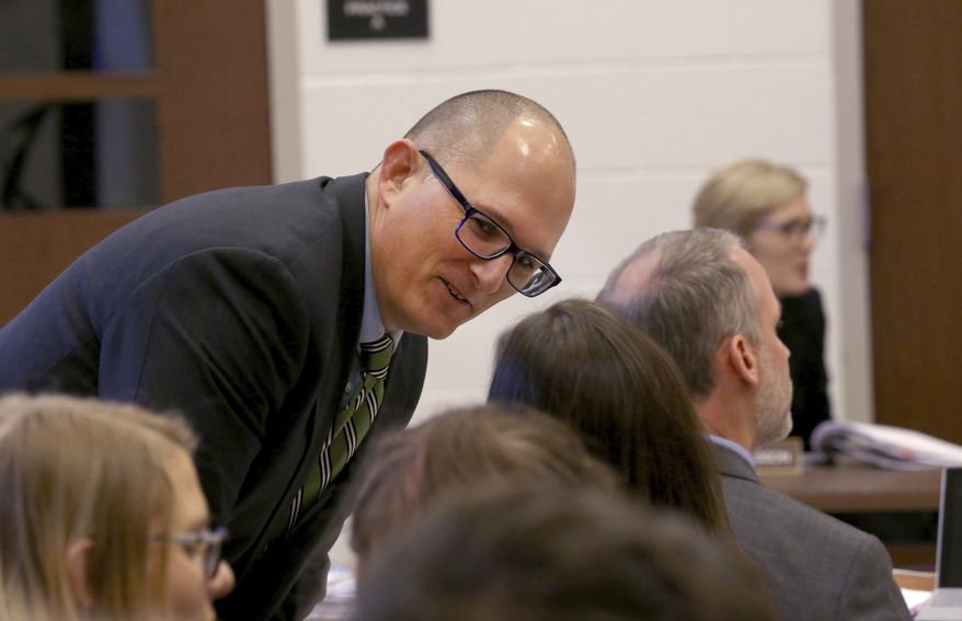In this Thursday Dec. 6, 2018 photo, high school teacher Peter Vlaming chats at a West Point School Board hearing in West Point, Va. The board voted unanimously to dismiss Vlaming, a high school teacher who refused to use a transgender student&#x27;s new pronouns. (Shelby Lum/Richmond Times-Dispatch via AP)