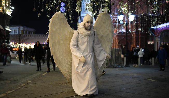A street actor dressed as an angel walks near Red Square in Moscow, Russia, late Monday, Feb. 14, 2022. While the U.S. warns that Russia could invade Ukraine any day, the drumbeat of war is all but unheard in Moscow, where political experts and ordinary people alike don&#x27;t expect President Vladimir Putin to launch an attack on the ex-Soviet neighbor. (AP Photo/Alexander Zemlianichenko)
