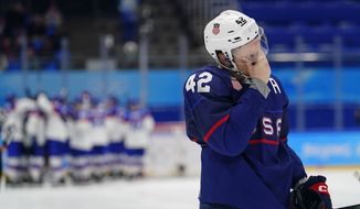 United States&#39; Aaron Ness (42) leaves the ice as Slovakia players celebrate behind him after a men&#39;s quarterfinal hockey game at the 2022 Winter Olympics, Wednesday, Feb. 16, 2022, in Beijing. Slovakia won 3-2 in a shoot-out. (AP Photo/Matt Slocum)