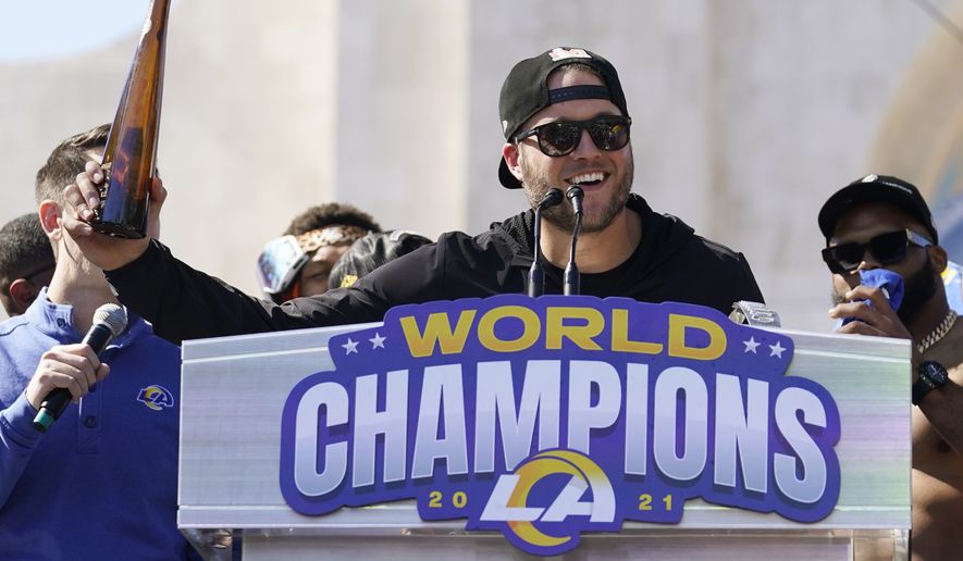 Los Angeles Rams quarterback Matthew Stafford holds up a bottle during the team&#x27;s victory celebration and parade in Los Angeles, Wednesday, Feb. 16, 2022, following the Rams&#x27; win Sunday over the Cincinnati Bengals in the NFL Super Bowl 56 football game. (AP Photo/Marcio Jose Sanchez)