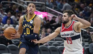 Indiana Pacers&#39; Tyrese Haliburton (0) goes to the basket against Washington Wizards&#39; Raul Neto (19) during the first half of an NBA basketball game, Wednesday, Feb. 16, 2022, in Indianapolis. Indiana won 113-108. (AP Photo/Darron Cummings)