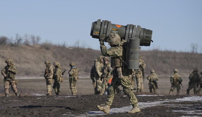 A Ukrainian serviceman carries an NLAW anti-tank weapon during an exercise in the Joint Forces Operation, in the Donetsk region, eastern Ukraine, Tuesday, Feb. 15, 2022. While the U.S. warns that Russia could invade Ukraine any day, the drumbeat of war is all but unheard in Moscow, where pundits and ordinary people alike don&#x27;t expect President Vladimir Putin to launch an attack on its ex-Soviet neighbor. (AP Photo/Vadim Ghirda)