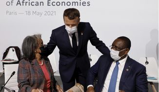 French President Emmanuel Macron, center, salutes Ethiopia&#39;s President Sahle-Work Zewde, left, and Senegal&#39;s President Macky Sall at the Summit on the Financing of African Economies on May 18, 2021, in Paris. European Union leaders want to reengage with African nations and counter the growing influence from China and Russia across the continent during a two-day summit in Brussels. The EU-African Union gathering starting Thursday, Feb. 17, 2022, was initially planned for 2020 but was postponed due to the coronavirus pandemic and agenda issues. So it&#39;s the first time EU and African Union leaders meet in that format since 2017. (Photo by Ludovic Marin, Pool via AP)