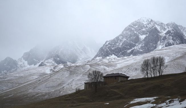 A house stands in the shadow of snow-capped mountains in predominantly-Tibetan Garze county in southwestern China&#x27;s Sichuan province, on Saturday, Feb. 5, 2022. Ahead of the Beijing summer Olympics 14 years ago, Tibet was on fire. Deadly clashes between Tibetans and security forces in Lhasa made global headlines, and for weeks, monks and herders battled bullets and batons.  But today, Tibet has fallen silent, even as the Olympic games come to Beijing for a second time. (AP Photo/Dake Kang)