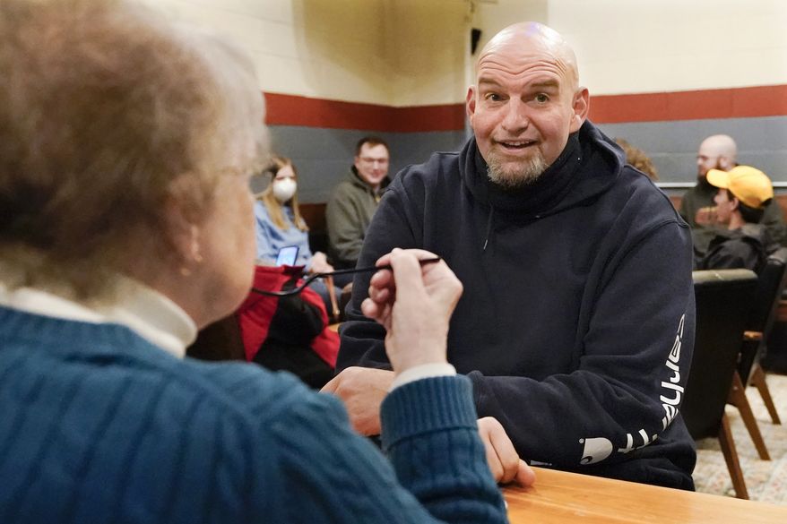 Democratic candidate for the Pennsylvania U.S. Senate seat in the 2022 primary election, Lt. Gov. John Fetterman, right, talks with Elisabeth Fulmer during a campaign stop at the Mechanistic Brewery, in Clarion, Pa., Saturday, Feb. 12, 2022. (AP Photo/Keith Srakocic)