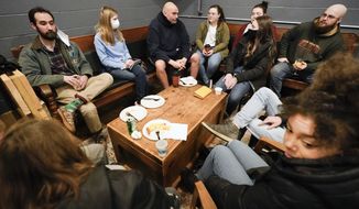 Democratic candidate for the Pennsylvania U.S.senate seat in the 2022 primary election, Lt. Gov. John Fetterman, center, talks with people during a campaign stop at the Mechanistic Brewery, in Clarion, Pa., Saturday, Feb. 12, 2022. The Democratic Party&#39;s brand is so toxic in some parts of rural America that liberals are removing bumper stickers and refusing to acknowledge their party affiliation publicly.  (AP Photo/Keith Srakocic)