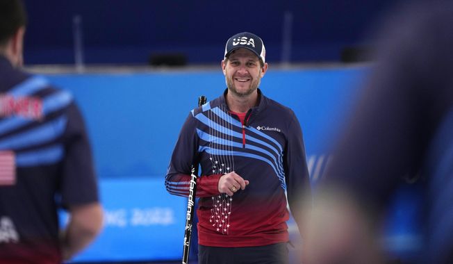 United States&#x27; John Shuster smiles between ends during a men&#x27;s curling semifinal match between Britain and the United States at the 2022 Winter Olympics, Thursday, Feb. 17, 2022, in Beijing. (AP Photo/Nariman El-Mofty)