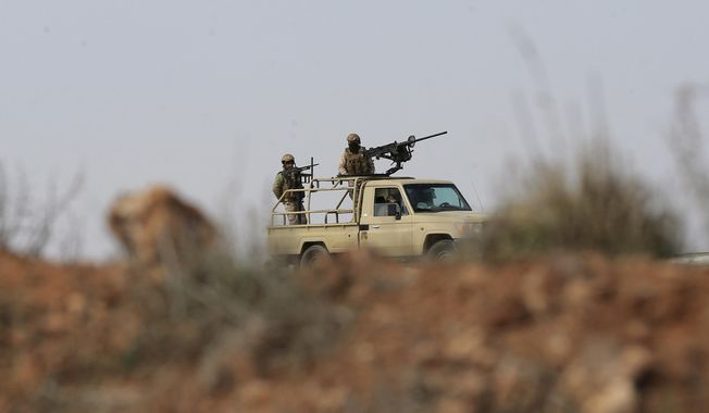 Jordanian soldiers patrol near the eastern Jordan-Syria border, in al-Washash, Mafraq governorate, Jordan, Thursday, Feb. 17, 2022, during media tour organised by the Jordanian army. Colonel Mustafa Al-Hiyari, head of the Military Information Directorate said Jordan is directly confronted with an undeclared war with drug smugglers and arms dealers. (AP Photo/Raad Adayleh) ** FILE **