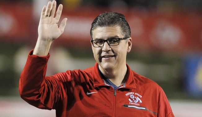 FILE - Joseph I. Castro, at the time president of Fresno State, waves to the crowd before the team&#x27;s NCAA college football game Nov. 4, 2017, against BYU in Fresno, Calif. Castro has resigned as chancellor of California State University after accusations that he mishandled sexual misconduct allegations. The CSU Board of Trustees says Castro resigned Thursday, Feb. 17, 2022, effective immediately. (AP Photo/Gary Kazanjian, File)