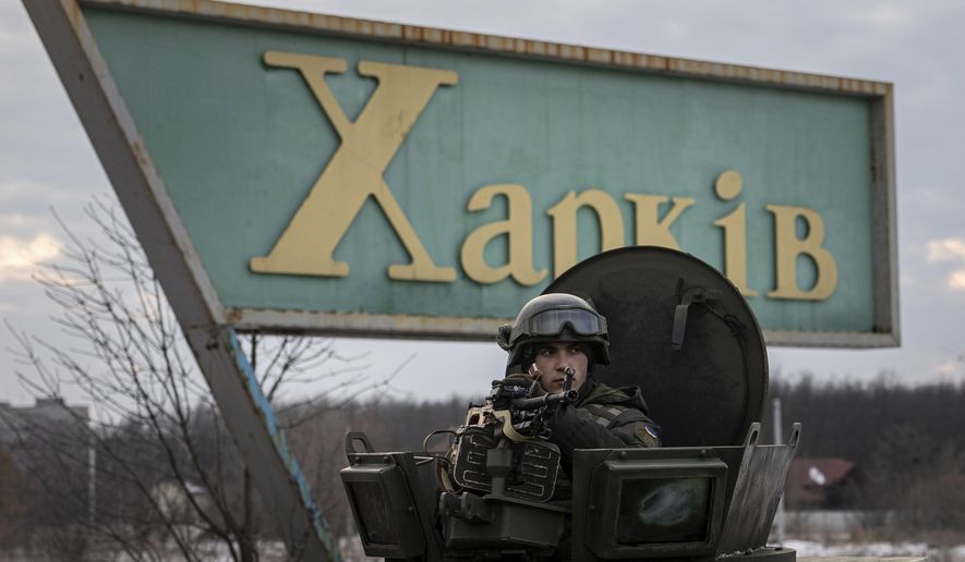 A Ukrainian National guard soldier guards the mobile checkpoint together with the Ukrainian Security Service agents and police officers during a joint operation in Kharkiv, Ukraine, Thursday, Feb. 17, 2022. Fears of a new war in Europe have resurged as U.S. President Joe Biden warned that Russia could invade Ukraine within days, and violence spiked in a long-running standoff in eastern Ukraine that some fear could be the spark for wider conflict. (AP Photo/Evgeniy Maloletka)
