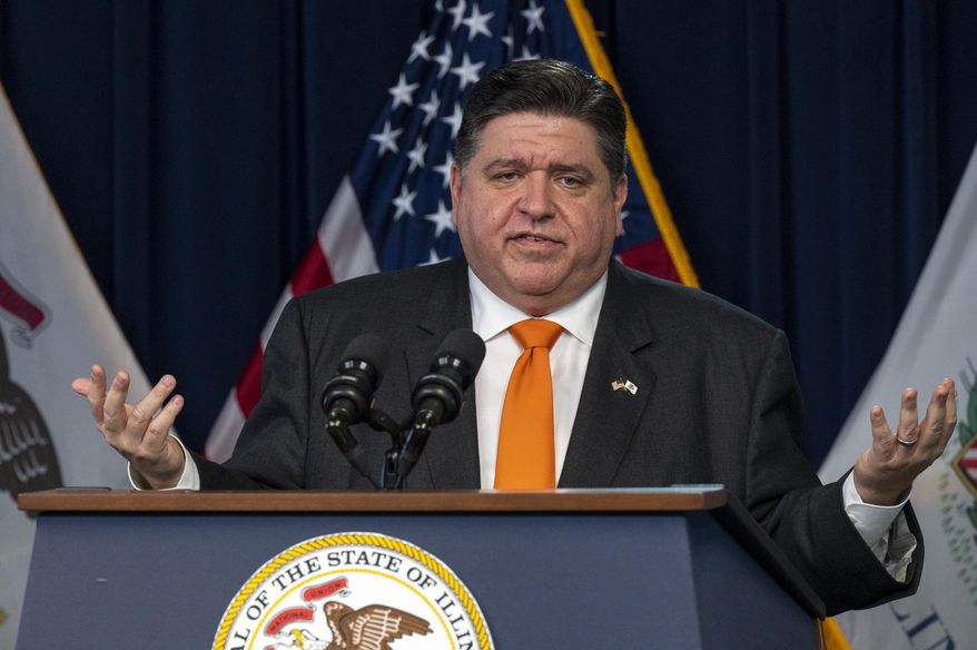 Illinois Gov. J.B. Pritzker gives a COVID-19 update to reporters in the Blue Room at the Thompson Center in Chicago, on Feb. 9, 2022. Pritzker announced last week that at the end of the month he will lift the requirement for face coverings to be worn in most indoor spaces to slow the spread of COVID-19, but the mandate will stay in place for K-12 schools where students, teachers and staff are clustered together. (Tyler LaRiviere/Chicago Sun-Times via AP, File)