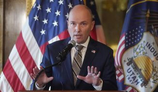 Utah Gov. Spencer Cox speaks during a news conference at the Utah State Capitol, Friday, Feb. 18, 2022, in Salt Lake City. Cox said that Utah planned to join the growing list of states planning to transition away from treating the pandemic as a public health crisis and toward managing risk. (AP Photo/Rick Bowmer)
