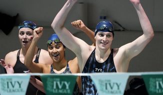 Members of Pennsylvania&#39;s 400 yard freestyle relay team from left Margot Kaczorowski, Hannah Kannan and Lia Thomas, right, celebrate after winning the race at the Ivy League Women&#39;s Swimming and Diving Championships at Harvard University, Saturday, Feb. 19, 2022, in Cambridge, Mass. (AP Photo/Mary Schwalm)