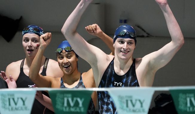 Members of Pennsylvania&#x27;s 400 yard freestyle relay team from left Margot Kaczorowski, Hannah Kannan and Lia Thomas, right, celebrate after winning the race at the Ivy League Women&#x27;s Swimming and Diving Championships at Harvard University, Saturday, Feb. 19, 2022, in Cambridge, Mass. (AP Photo/Mary Schwalm)