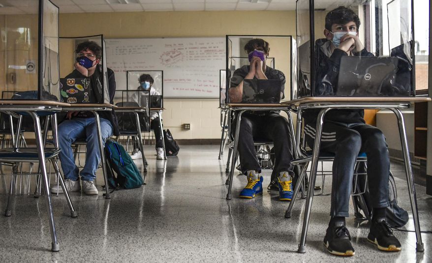 Students listen to a presentation in Health class at Windsor Locks High School in Windsor Locks, Conn., March 18, 2021. Connecticut officials have released guidance for how K-12 schools across the state should handle face mask. It comes as local districts are preparing for the statewide mask mandate to end on Feb. 28, 2022. (AP Photo/Jessica Hill, File)