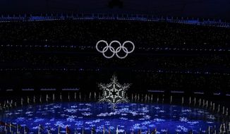 The Olympic rings illuminate during the closing ceremony of the 2022 Winter Olympics, Sunday, Feb. 20, 2022, in Beijing. (AP Photo/Brynn Anderson)