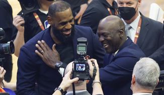 Los Angeles Lakers&#39; LeBron James, left, and former NBA great Michale Jordan greet each other during the introduction of 75 of the leagues greatest player during halftime at the NBA All-Star basketball game, Sunday, Feb. 20, 2022, in Cleveland. (AP Photo/Ron Schwane)