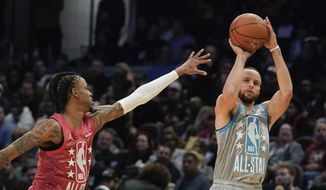 Golden State Warriors&#39; Stephen Curry, right, shoots for three as Memphis Grizzlies&#39; Ja Morant defends during the second half of the NBA All-Star basketball game, Sunday, Feb. 20, 2022, in Cleveland. (AP Photo/Charles Krupa)