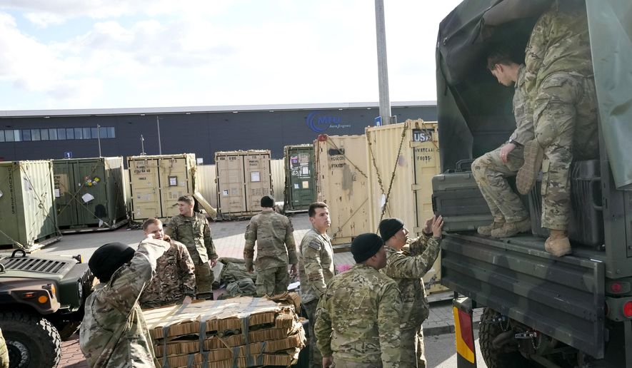 U.S. troops load equipment onto vehicles in Rzeszow, Poland, on Saturday, Feb. 19, 2022. The U.S. has recently sent nearly 5,000 troops to NATO ally Poland, in addition to the 4,000 that are on a permanent rotation in Poland. (AP Photo/Czarek Sokolowski) ** FILE **