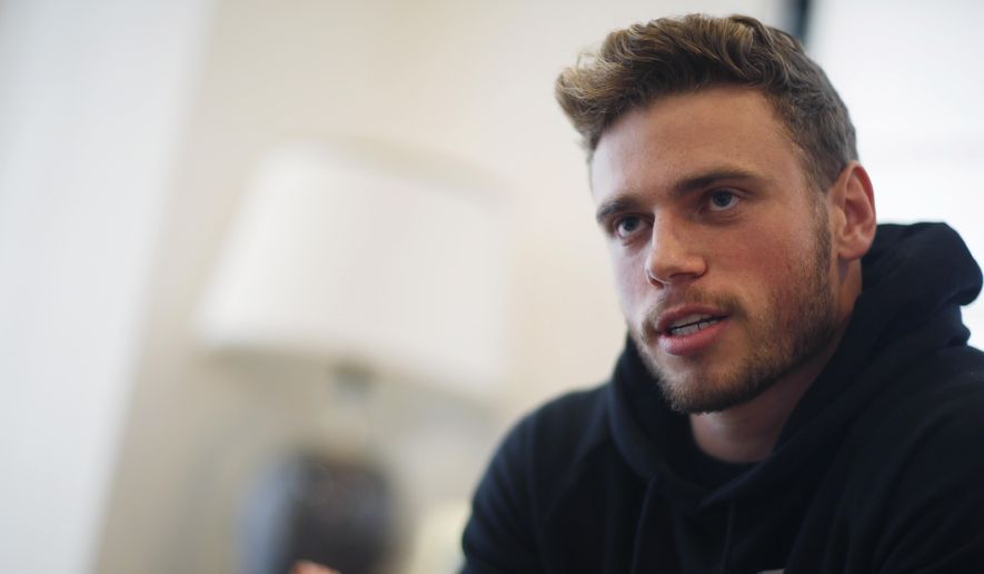 Gus Kenworthy, a freestyle skier who won a silver medal in Sochi, speaks in his home in Denver on Oct. 21, 2015. “We’re in China, so we play by China’s rules. And China makes their rules as they go, and they certainly have the power to kind of do whatever they want: Hold an athlete, stop an athlete from leaving, stop an athlete from competing,” Kenworthy said on Sunday, Feb. 20, at the 2022 Beijing Olympics. (AP Photo/David Zalubowski, File) ** FILE**