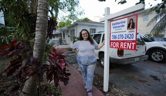 Krystal Guerra, 32, poses for a picture outside her apartment, which she has to leave after her new landlord gave her less than a month&#39;s notice that her rent would go up by 26%, Saturday, Feb. 12, 2022, in the Coral Way neighborhood of Miami. Guerra, who works in marketing while also pursuing a degree part-time, had already been spending nearly 50% of her monthly income on rent prior to the increase. Unable to afford a comparable apartment in the area as rents throughout the city have risen dramatically, Guerra is putting many of her belongings into storage and moving in with her boyfriend and his daughter for the time being. (AP Photo/Rebecca Blackwell)
