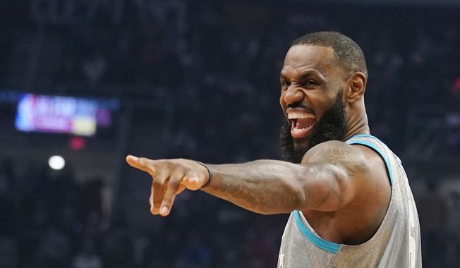 Los Angeles Lakers&#x27; LeBron James jokes with fans during the NBA All-Star game in Cleveland, Sunday, Feb. 20, 2022. (AP Photo/Charles Krupa) **FILE**