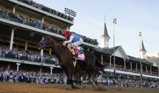John Velazquez riding Medina Spirit crosses the finish line to win the 147th running of the Kentucky Derby at Churchill Downs in Louisville, Ky., in this Saturday, May 1, 2021, file photo. Medina Spirit was stripped of the victory in last year’s Kentucky Derby and Mandaloun was declared the winner in a ruling by state racing stewards on Monday, Feb. 21, 2022. (AP Photo/Jeff Roberson, File) **FILE**