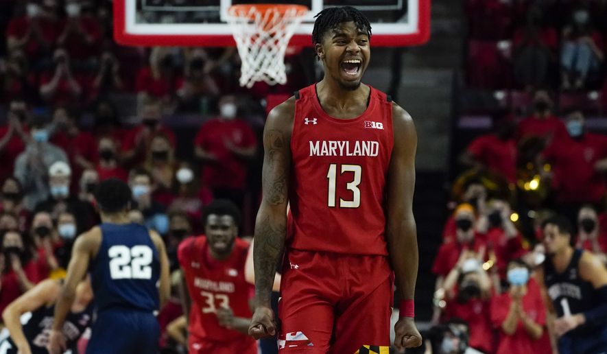 Maryland guard Hakim Hart (13) reacts after a basket by forward Qudus Wahab (33) against Penn State during the first half of an NCAA college basketball game, Monday, Feb. 21, 2022, in College Park, Md. (AP Photo/Julio Cortez)
