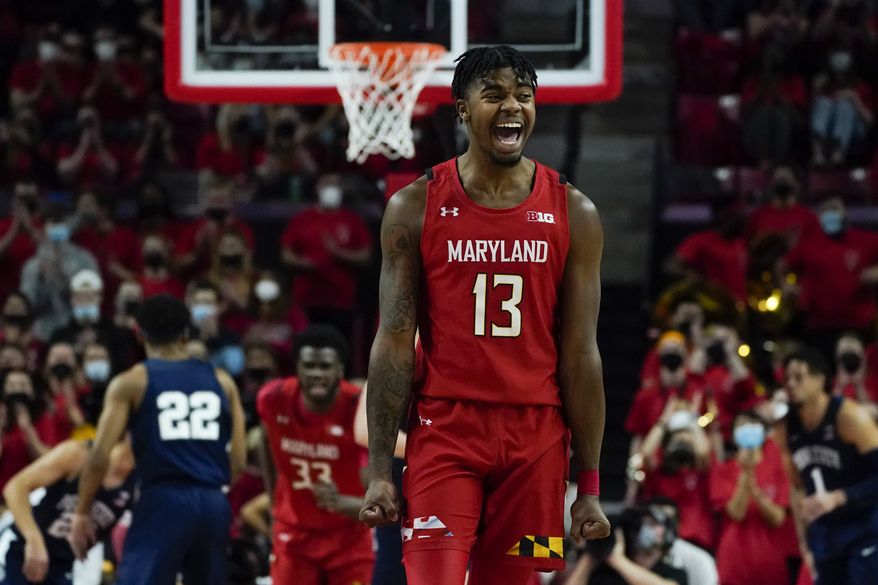 Maryland guard Hakim Hart (13) reacts after a basket by forward Qudus Wahab (33) against Penn State during the first half of an NCAA college basketball game, Monday, Feb. 21, 2022, in College Park, Md. (AP Photo/Julio Cortez)