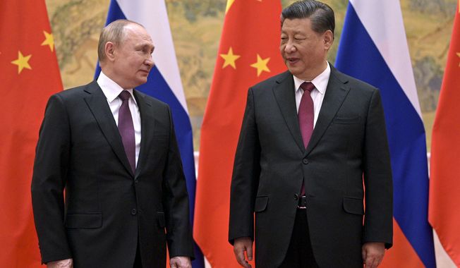 Chinese President Xi Jinping, right, and Russian President Vladimir Putin talk to each other during their meeting in Beijing, Friday, Feb. 4, 2022. China&#x27;s communist leaders face the dilemma of supporting a quasi-ally in backing Russian military operation against Ukraine while avoiding a collapse of Beijing&#x27;s declared policy of respecting and never interfering in the internal affairs of other states. (Alexei Druzhinin, Sputnik, Kremlin Pool Photo via AP, File)