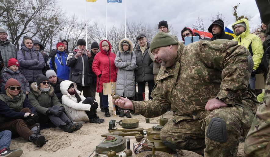 An instructor, right, shows a grenade during a training of members of a Ukrainian far-right group train, in Kyiv, Ukraine, Sunday, Feb. 20, 2022. Russia extended military drills near Ukraine&#39;s northern borders Sunday amid increased fears that two days of sustained shelling along the contact line between soldiers and Russa-backed separatists in eastern Ukraine could spark an invasion. (AP Photo/Efrem Lukatsky)