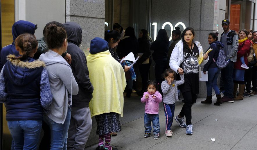 In this Jan. 31, 2019, file photo, hundreds of people overflow onto the sidewalk in a line snaking around the block outside a U.S. immigration office with numerous courtrooms in San Francisco. Federal judges are being asked to block a new Trump administration policy scheduled to take effect next week that would deny legal permanent residency to many immigrants over the use of public benefits. Almost a dozen lawsuits have been filed from New York to California to prevent the &quot;public charge&quot; rule from taking effect on Oct. 15. Judges have indicated a willingness to issue rulings before the scheduled start date. (AP Photo/Eric Risberg, File)