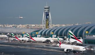 An Emirates jetliner comes in for landing at the Dubai International Airport in Dubai, United Arab Emirates, on Dec. 11, 2019. Dubai&#39;s main airport said Tuesday, Feb. 22, 2022, it has retained its top place as the world&#39;s busiest for international travel with around 29 million passengers making their way through the gateway that&#39;s positioned itself as a critical link between East and West. (AP Photo/Jon Gambrell, File)