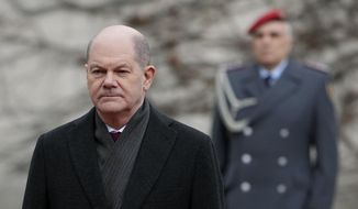 German Chancellor Olaf Scholz waits for Ireland&#39;s Prime Minister Micheal Martin at the chancellery in Berlin, Germany, Tuesday, Feb. 22, 2022. (AP Photo/Michael Sohn)