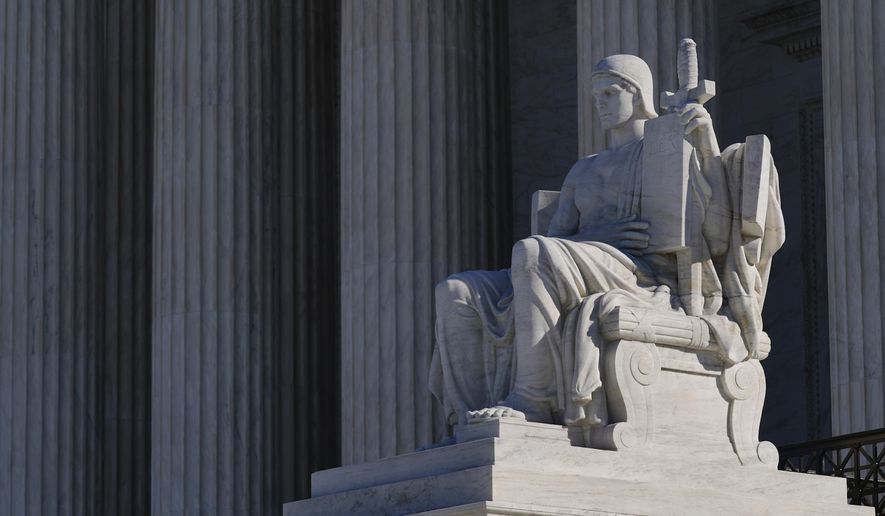 &#x27;The Authority of Law&#x27; sculpted by James Earle Fraser, stands outside the Supreme Court building on Capitol Hill in Washington, Monday, Feb. 21, 2022. (AP Photo/Patrick Semansky)