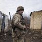 A Ukrainian serviceman stands at his position at the line of separation between Ukraine-held territory and rebel-held territory near Svitlodarsk, eastern Ukraine, Wednesday, Feb. 23, 2022. U.S. President Joe Biden announced the U.S. was ordering heavy financial sanctions against Russia, declaring that Moscow had flagrantly violated international law in what he called the &quot;beginning of a Russian invasion of Ukraine.&quot; (AP Photo/Evgeniy Maloletka)