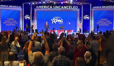 Supporters cheer and wave as former President Donald Trump is introduced at the Conservative Political Action Conference (CPAC) Sunday, Feb. 28, 2021, in Orlando, Fla. (AP Photo/John Raoux)
