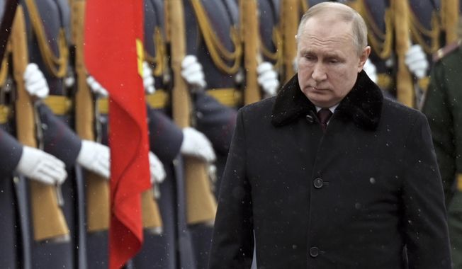 Russian President Vladimir Putin attends a wreath-laying ceremony at the Tomb of the Unknown Soldier, near the Kremlin Wall during the national celebrations of the &#x27;Defender of the Fatherland Day&#x27; in Moscow, Russia, Wednesday, Feb. 23, 2022. The Defenders of the Fatherland Day, celebrated in Russia on Feb. 23, honors the nation&#x27;s military and is a nationwide holiday. (Alexei Nikolsky, Kremlin Pool Photo via AP)