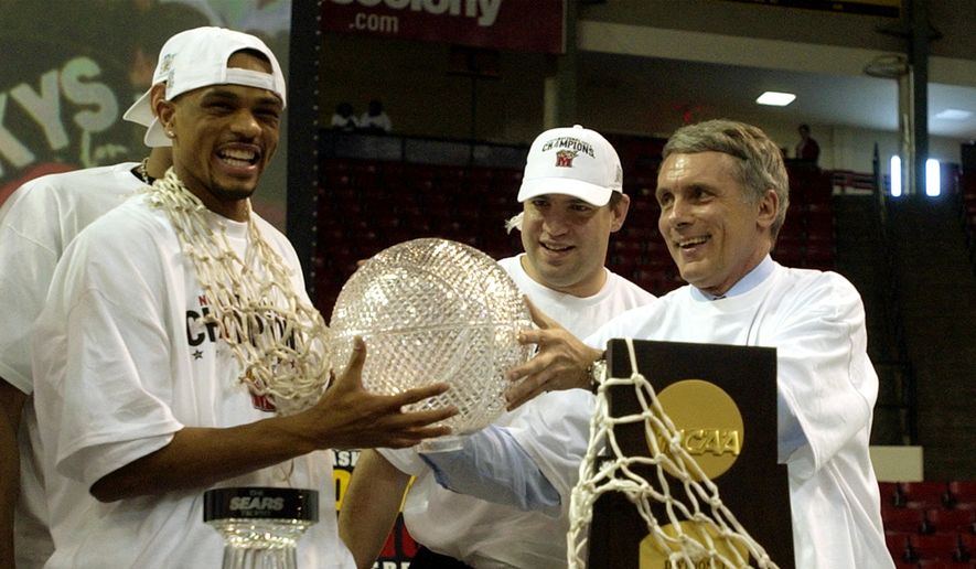 In this file photo taken April 2, 2002, Maryland basketball player Juan Dixon, left, jokes around with the Sears trophy with head coach Gary Williams, right, as assistant coach Jimmy Patsos, center, looks on during a ceremony to honor Maryland&#39;s NCAA National Championship win over Indiana at Cole Field House in College Park, Md. At right foreground is the NCAA National Championship trophy. (AP Photo/Nick Wass, File) **FILE**