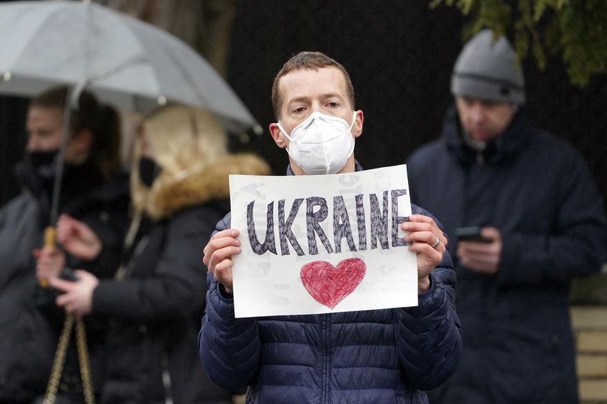 People gather outside the Russian Embassy in Washington, Thursday, Feb. 24, 2022, protesting the Russian invasion of Ukraine. (AP Photo/Susan Walsh)