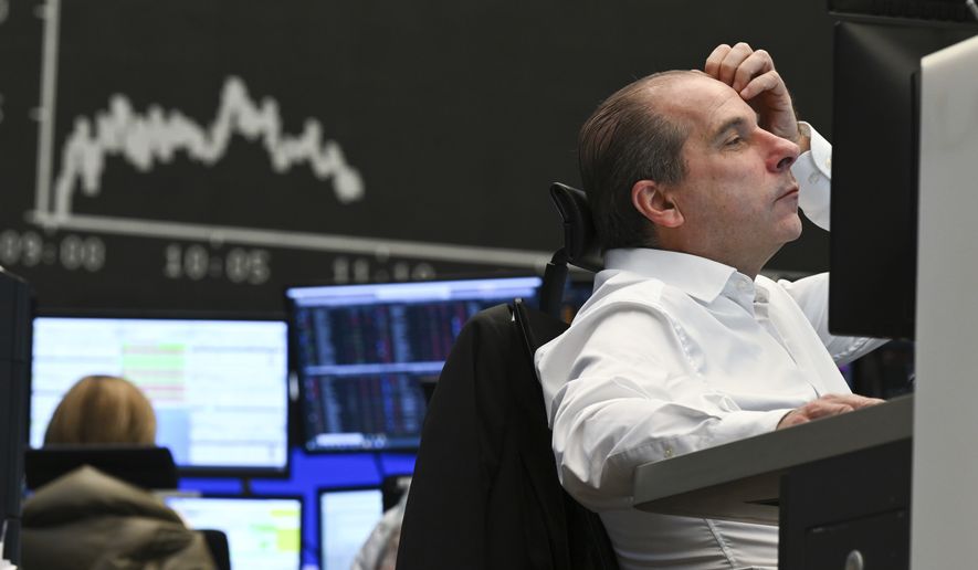 Stock trader Arthur Brunner of ICF Bank AG watches his monitor on the floor of the Frankfurt Stock Exchange. The Russian attack on Ukraine has sent stock markets worldwide on a downward slide in Frankfurt, Germany, Thursday, Feb. 24, 2022. For the German benchmark index Dax, it went down by more than four percent at the start of trading. The other stock markets around the globe also slumped. (Arne Dedert/dpa via AP)