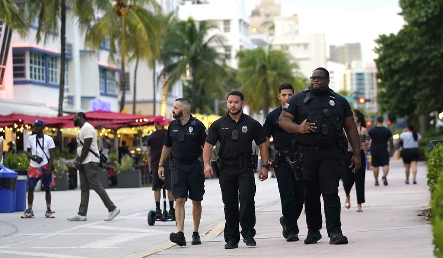 City of Miami Beach code enforcement and police officers patrol along Ocean Drive, Friday, Sept. 24, 2021, in Miami Beach, Fla. An alcohol ban designed to curb heavy late-night drinking among spring breakers in Miami Beach will be in effect for two weeks in March. The city's commissioners voted 4-3 Wednesday, Feb. 23, 2022, to prohibit the sale and consumption of alcohol after 2 a.m. between March 7 and March 21 along the city's South Beach entertainment district. (AP Photo/Lynne Sladky)