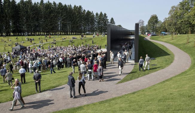 People gather at The Memorial of Victims of Communism to mark the European Day of Remembrance for Victims of Stalinism and Nazism, also known as Black Ribbon Day, in Tallinn, Estonia, Thursday, Aug. 23, 2018. To Estonians, Latvians and Lithuanians, Russia&#x27;s belligerence toward Ukraine has some worried that they could be the Kremlin&#x27;s next target. The tensions are bringing back memories of dictatorship and oppression. (AP Photo/Raul Mee)
