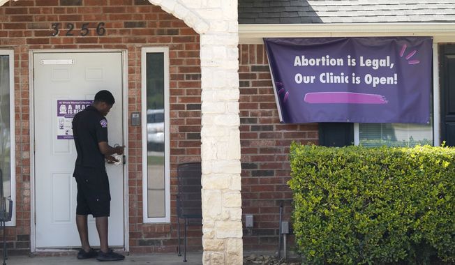 A security guard opens the door to the Whole Women&#x27;s Health Clinic in Fort Worth, Texas, Wednesday, Sept. 1, 2021. Texas has released data showing a marked drop in abortions at clinics in the state in the first month under the nation&#x27;s strictest abortion law, but that only tells part of the story, Friday, Feb. 25, 2022 (AP Photo/LM Otero, File)