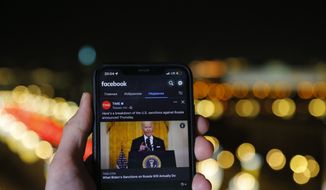 The app of Facebook showing U.S. President Joe Biden speaking, is viewed on an smartphone in Moscow, Russia, Friday, Feb. 25, 2022. Russia announces &#39;partial restriction&#39; of access to Facebook over platform&#39;s restrictions on Kremlin-backed media. (AP Photo)