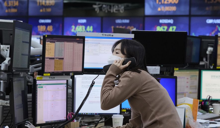 A currency trader talks on the phone at the foreign exchange dealing room of the KEB Hana Bank headquarters in Seoul, South Korea, Thursday, Feb. 24, 2022. (AP Photo/Ahn Young-joon)