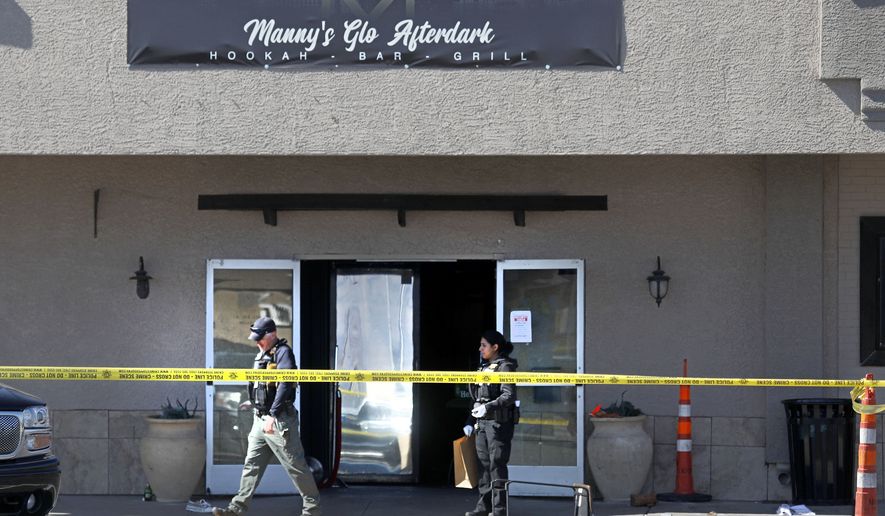 Las Vegas police investigate at Manny&#39;s Glow Ultra Lounge &amp; Restaurant, after a shooting, Saturday, Feb. 26, 2022, in Las Vegas. Multiple people were shot before dawn Saturday morning at a hookah parlor. (Chitose Suzuki/Las Vegas Review-Journal via AP)