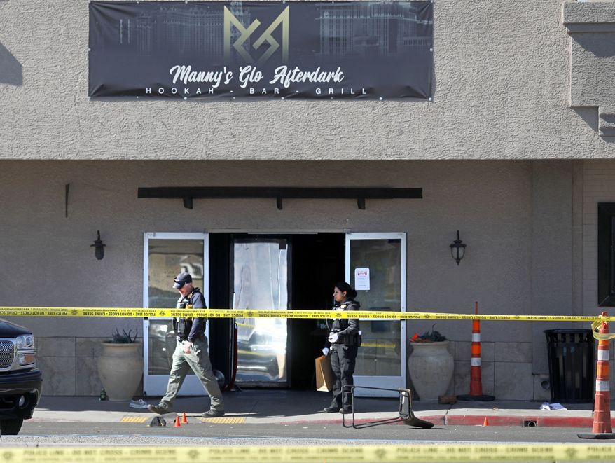 Las Vegas police investigate at Manny&#39;s Glow Ultra Lounge &amp; Restaurant, after a shooting, Saturday, Feb. 26, 2022, in Las Vegas. Multiple people were shot before dawn Saturday morning at a hookah parlor. (Chitose Suzuki/Las Vegas Review-Journal via AP)