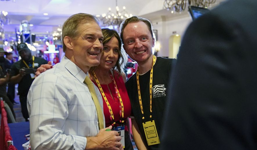 Rep. Jim Jordan, R-Ohio, left, poses for a photo with supporters at the Conservative Political Action Conference (CPAC) Saturday, Feb. 26, 2022, in Orlando, Fla. (AP Photo/John Raoux)